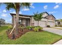 Two-car garage, paver driveway, and nicely landscaped yard at 19315 Hawk Valley Dr, Tampa, FL 33647