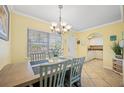 Dining area with light walls and view into kitchen at 19417 Gulf Blvd # C-211, Indian Shores, FL 33785