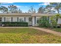 Front view of house showing landscaping and walkway at 39650 Us Highway 19 N # 233, Tarpon Springs, FL 34689