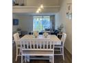 Spacious dining area with a white table and chairs, offering plenty of room at 4220 Players Pl # 2221, Sarasota, FL 34238