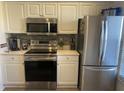 Modern kitchen featuring stainless steel appliances and light-colored cabinetry at 4220 Players Pl # 2221, Sarasota, FL 34238
