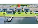Aerial view of a house near a canal with a boat dock at 5221 Wishing Arch Dr, Apollo Beach, FL 33572