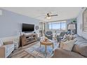 Bright living room with water views, comfy seating, and hardwood floors at 6372 Palma Del Mar S Blvd # 807, St Petersburg, FL 33715