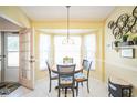 Eat-in kitchen with white cabinets, bay window, and breakfast nook at 8015 Willow Brook Dr, Spring Hill, FL 34606