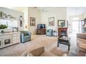 Spacious living room with carpeting, fireplace, and ample natural light at 8015 Willow Brook Dr, Spring Hill, FL 34606