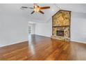 Living room features hardwood floors, a stone fireplace, and high ceilings at 9446 Laura Anne Dr, Seminole, FL 33776