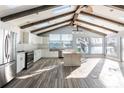 Modern kitchen features stainless steel appliances, island, and vaulted ceiling at 12417 84Th Way, Largo, FL 33773