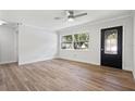 Bright living room with hardwood floors, ceiling fan and large windows at 15111 Verona Ave, Clearwater, FL 33760