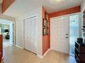 Inviting entryway with a wood-look floor, bi-fold closet, and a stylish front door with side window at 2281 Lake Arbor Blvd, Clearwater, FL 33763