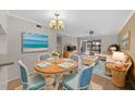 Bright dining area with table and chairs, view to living room and patio at 2679 Sabal Springs Cir # 203, Clearwater, FL 33761