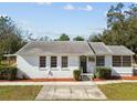 Single-story house featuring a classic design and a neat lawn at 4512 70Th N St, St Petersburg, FL 33709