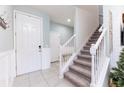 Bright entryway with staircase, tile flooring and coat rack at 6356 Camino Dr, Apollo Beach, FL 33572