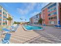 Outdoor pool with many lounge chairs at this condo community, perfect for relaxation at 6960 20Th N Ave # 306, St Petersburg, FL 33710