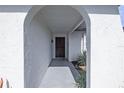 Covered entryway with arched entry and decorative door at 8209 Rugby Ct, Hudson, FL 34667