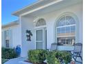 Inviting front porch with seating, beautiful landscaping, and decorative accents; perfect for relaxing at 9336 Villa Entrada, New Port Richey, FL 34655