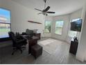 Spacious home office with a large desk, plenty of natural light, and room for a large TV at 11715 Bitola Dr, Odessa, FL 33556