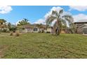Single story home with palm trees and a large yard at 512 Acacia Ln, Nokomis, FL 34275