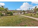 Ranch style home with a spacious lawn and walkway at 512 Acacia Ln, Nokomis, FL 34275