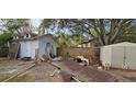 Backyard with sheds and various yard clutter at 6404 Pershing Ne St, St Petersburg, FL 33702