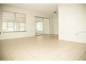 Spacious living room with tile floors and mirrored closet at 6741 Willits Ave, New Port Richey, FL 34655