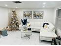 Spacious living room with white sectional sofa and marble flooring at 11511 Meredith Ln, Port Richey, FL 34668