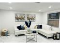 L shaped living room with white sectional and marble flooring at 11511 Meredith Ln, Port Richey, FL 34668