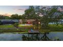 Backyard oasis with pool, dock, and lake view at 1307 Windjammer Pl, Valrico, FL 33594
