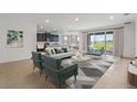 Open concept living room and kitchen with access to backyard at 16813 Harvest Moon Way, Lakewood Ranch, FL 34211