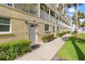 Condo building exterior showcasing walkway and landscaping at 17960 Gulf Blvd # 115, Redington Shores, FL 33708