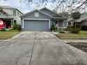Gray house with a two-car garage and a well-maintained lawn at 18229 Port Side St, Tampa, FL 33647