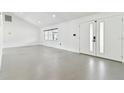 Bright and airy living room with tile floors and access to the backyard at 26728 Hickory Loop, Lutz, FL 33559