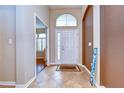 Inviting foyer with tile flooring and a large decorative window over the front door bringing in lots of light at 3406 Ranchdale Dr, Plant City, FL 33566