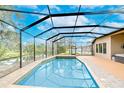 Relaxing screened in pool overlooking a tranquil pond, perfect for enjoying sunny days and outdoor living at 3406 Ranchdale Dr, Plant City, FL 33566