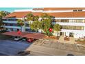 Building exterior with parking and landscaping at 2579 Countryside Blvd # 1105, Clearwater, FL 33761