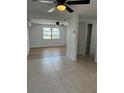 Open living area with tile floors and ceiling fans at 3630 Winder Dr, Holiday, FL 34691