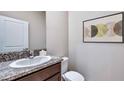 Small half bathroom with granite countertop and modern sink at 10596 Bridgegate Heights Loop, San Antonio, FL 33576