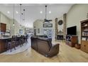 Open living space with a fireplace and kitchen island at 19505 Coachlight Way, Lutz, FL 33549