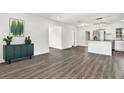 Open concept dining area with wood-look flooring and kitchen island at 4916 Carlyle Rd, Tampa, FL 33615