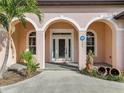 Elegant front entry with arched detail, white door, and decorative glass at 5269 61St N Way, Kenneth City, FL 33709