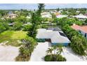 Bird's eye view of a light blue house, situated in a neighborhood near the water at 616 Lyons Ln, Longboat Key, FL 34228