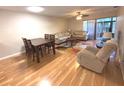 Bright living room features hardwood floors, comfy seating, and a dining area at 215 Valencia Blvd # 105, Belleair Bluffs, FL 33770