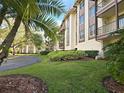 Exterior building view showcasing meticulously manicured lawns and mature landscaping for enhanced curb appeal at 3031 Countryside Blvd # 35C, Clearwater, FL 33761