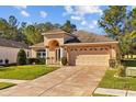 Charming single-Gathering home with a well-manicured lawn, paver driveway, two-car garage, and an inviting arched entryway at 4275 Caskie Pl, Brooksville, FL 34604