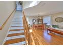 Open-concept living room showcasing hardwood floors and staircase at 12427 Adventure Dr, Riverview, FL 33579