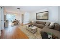 Bright living room featuring a cozy couch, stylish rug, and view of the dining area at 11805 Northtrail Ave, Temple Terrace, FL 33617