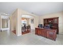 Open concept office space featuring wood furniture set on tile floors, and an adjacent dining area with wood floors at 20314 Chestnut Grove Dr, Tampa, FL 33647