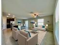 Open-concept living room flows seamlessly into the kitchen and dining areas, perfect for entertaining at 13621 Willow Bluestar Loop, Riverview, FL 33579