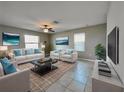 Bright living room featuring modern decor, a plush rug, and comfortable seating arrangements at 13621 Willow Bluestar Loop, Riverview, FL 33579