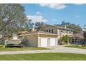 Spacious home exterior with a detached two-car garage, driveway, and well-maintained landscaping at 13945 75Th Ave, Seminole, FL 33776