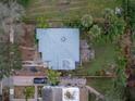 Aerial view of a charming home with a fenced backyard and lush greenery surrounding the property at 2932 W Alline Ave, Tampa, FL 33611